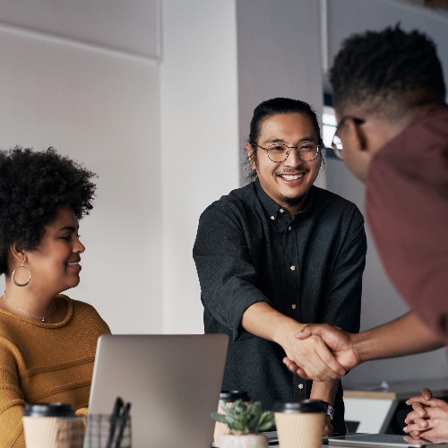 Creative office and business people with handshake agreement